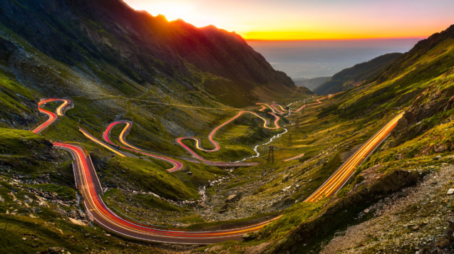 Traffic trails on Transfagarasan pass at sunset. Crossing Carpathian mountains in Romania, Transfagarasan is one of the most spectacular mountain roads in the world.
